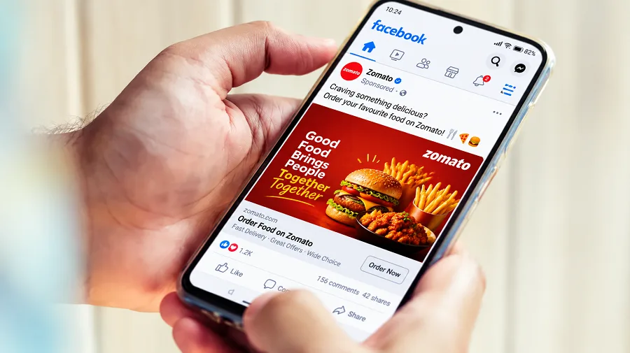 Customer opening the Zomato app on a smartphone to discover a restaurant
