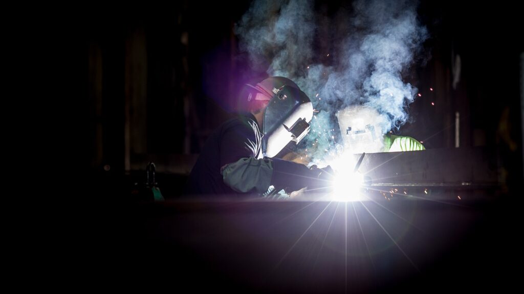 Two welders working on metal fabrication